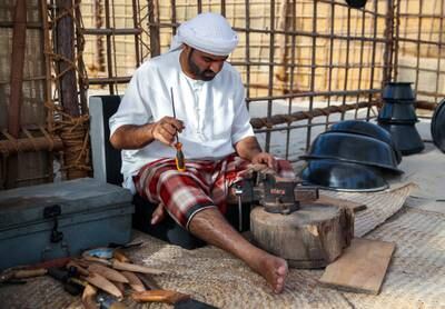 Emirati knife blacksmiths at work at the Maritime Heritage Festival in Al Bahar at the Corniche.