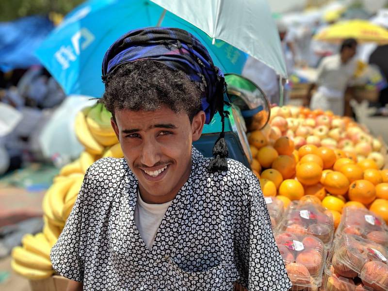 A fruit seller sets up shop on a busy intersection to sell fruit to pilgrims in Makkah, Saudi Arabia