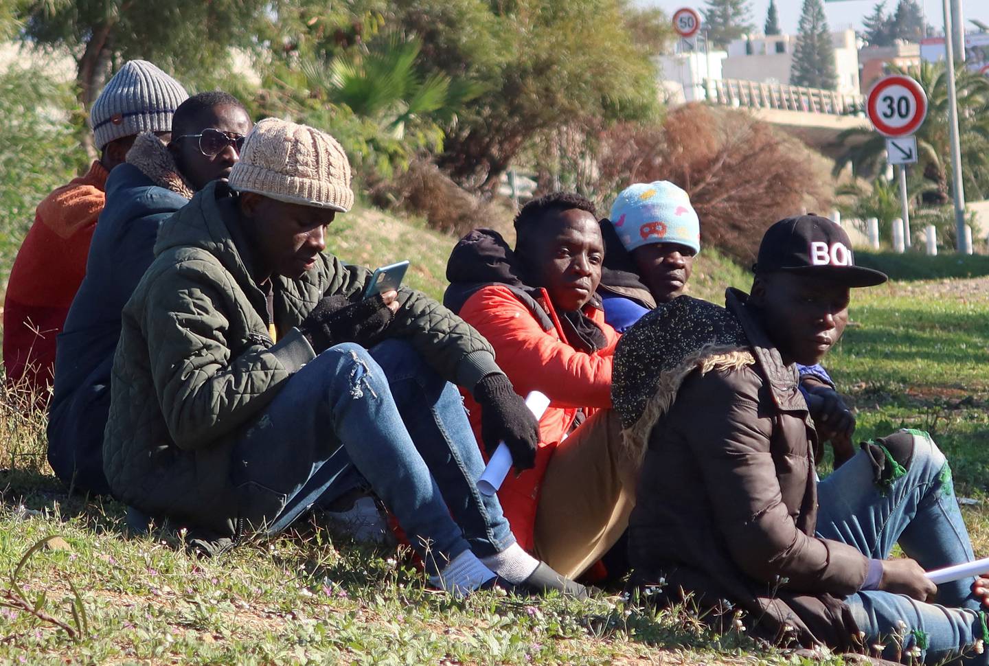 Ivory Coast citizens living in Tunisia wait near their country's embassy in Tunis as they seek repatriation. Reuters