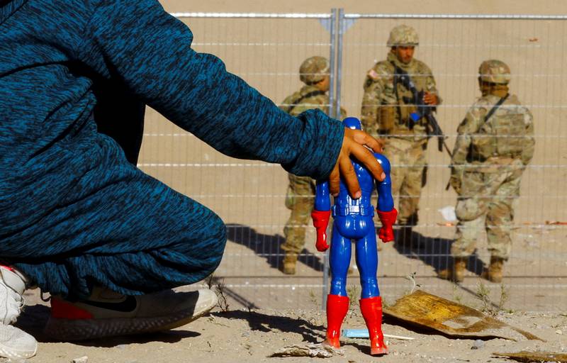 A migrant boy from Venezuela with a Captain America doll at the border between Mexico and the United States. Reuters