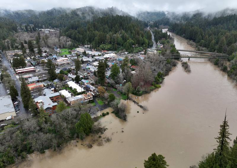 The Russian River, swollen with floodwaters, flows past the town of Guerneville. Reuters