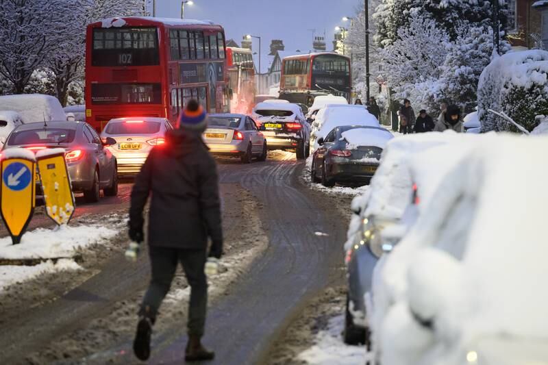 Cars wind around abandoned buses in London. Getty Images