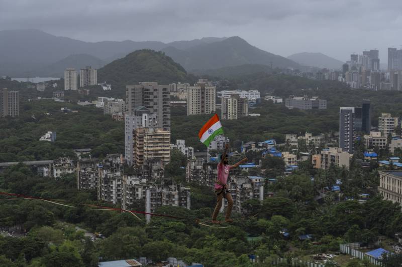 Tightrope artist Harshdeep Pawar carries the Indian flag while making a high-wire walk above the west coast city of Mumbai, to mark Independence Day. AP