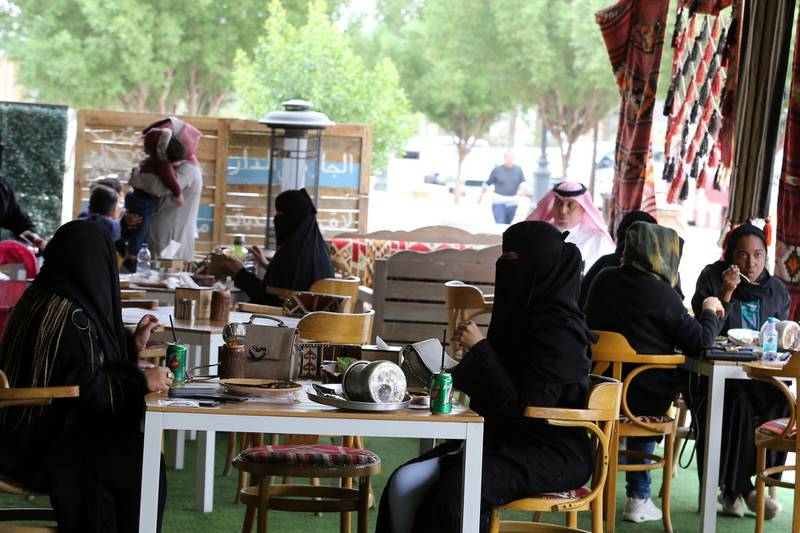 Men and women sit at cafe in Riyadh. Reuters