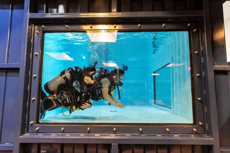 DUBAI, UNITED ARAB EMIRATES. 07 MARCH 2021. Michela Colella, Dive Instructor, conducts a training session with a learner diver in the newly opened indoor pool at the Dive Garage facility in Al Quoz 4. The pool is constructed out of shipping containers and hols a 100 000 liters of fresh water, making it one of a kind in the Middle East. (Photo: Antonie Robertson/The National) Journalist: Janice Rodriques. Section: National.