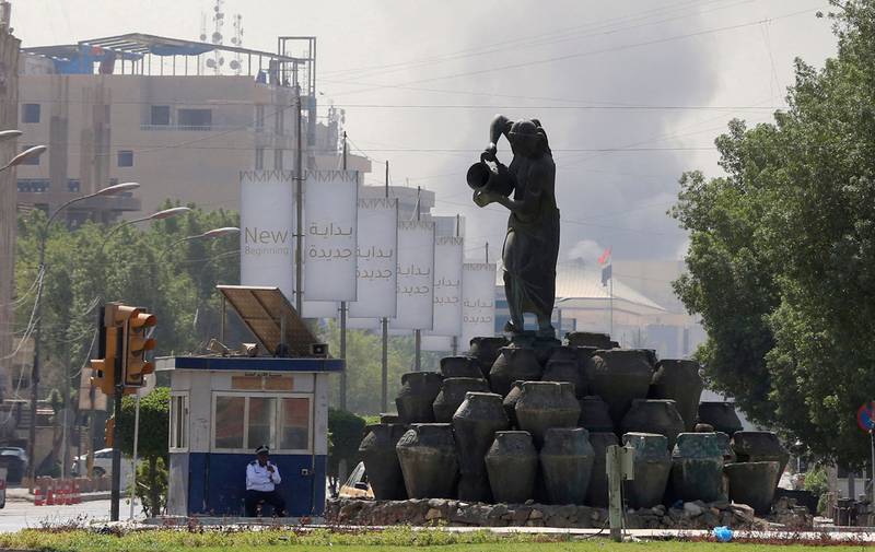 Smoke over Baghdad during an army-imposed curfew, a day after 23 Al Sadr supporters were shot dead. AFP