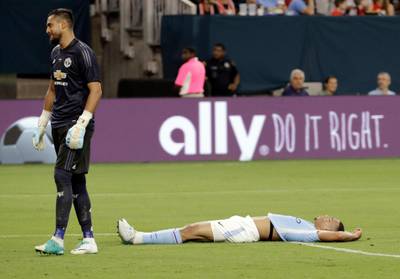 Manchester City's Gabriel Jesus, right, lays on the ground after missing a shot. David J. Phillip / AP Photo