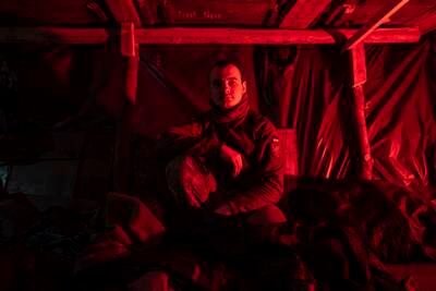 Vladyslav, a Ukrainian paratrooper of the 80 Air Assault brigade, rests in a dugout at the front line near Bakhmut. AP