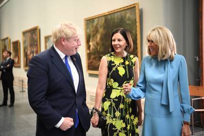British Prime Minister Boris Johnson, the first lady of France, Brigitte Macron, right, and Belgian Prime Minister Alexander De Croo's wife Annik Penders have a conversation at the museum. AP