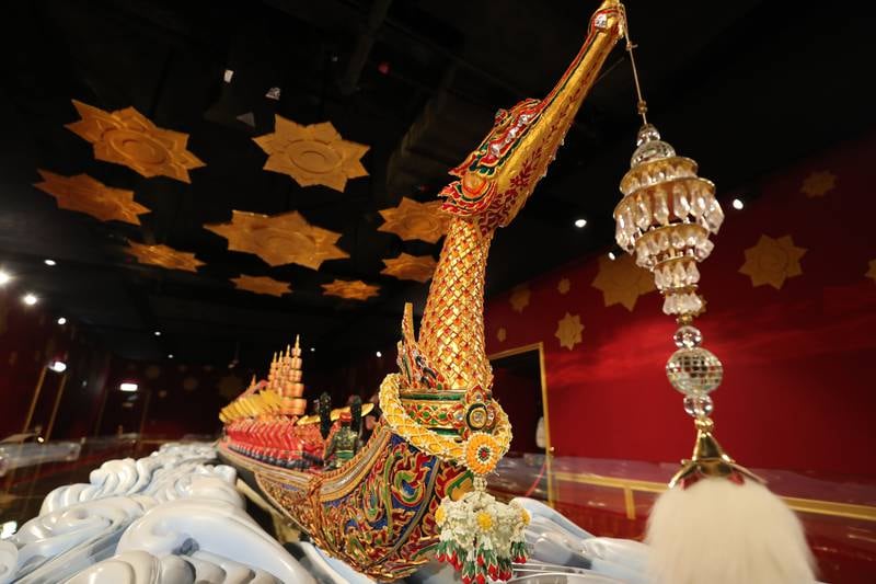 Visitors to the Thai pavilion look at a model of the Royal barge Suphannahong on the fifth day of Expo 2020 Dubai.