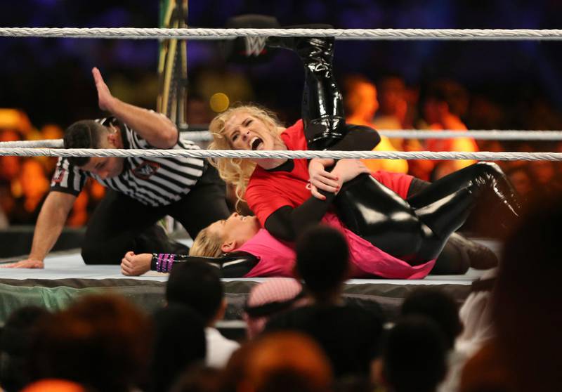 Evans, at top, takes down Natalya Neidhart. AP Photo