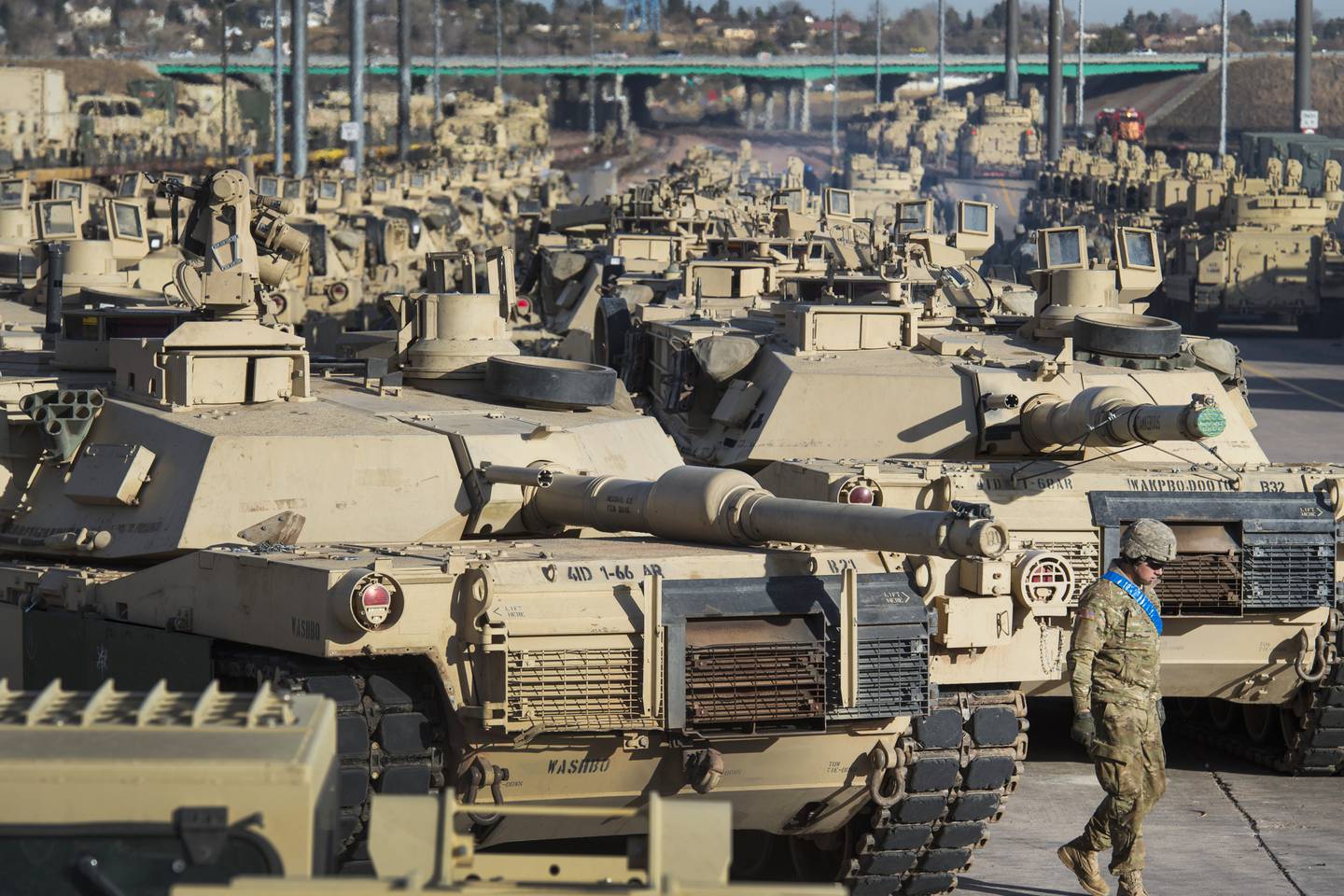 A soldier walks past a line of M1 Abrams tanks in 2016, in Colorado Springs. AP