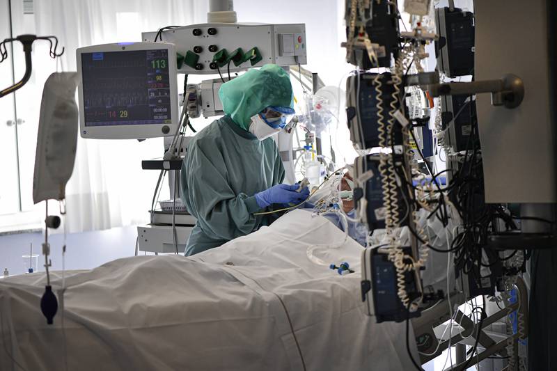 A medical staff member tends to a Covid-19 patient in the ICU of the Clinica Universitaria in Pamplona, northern Spain, on January 12. AP