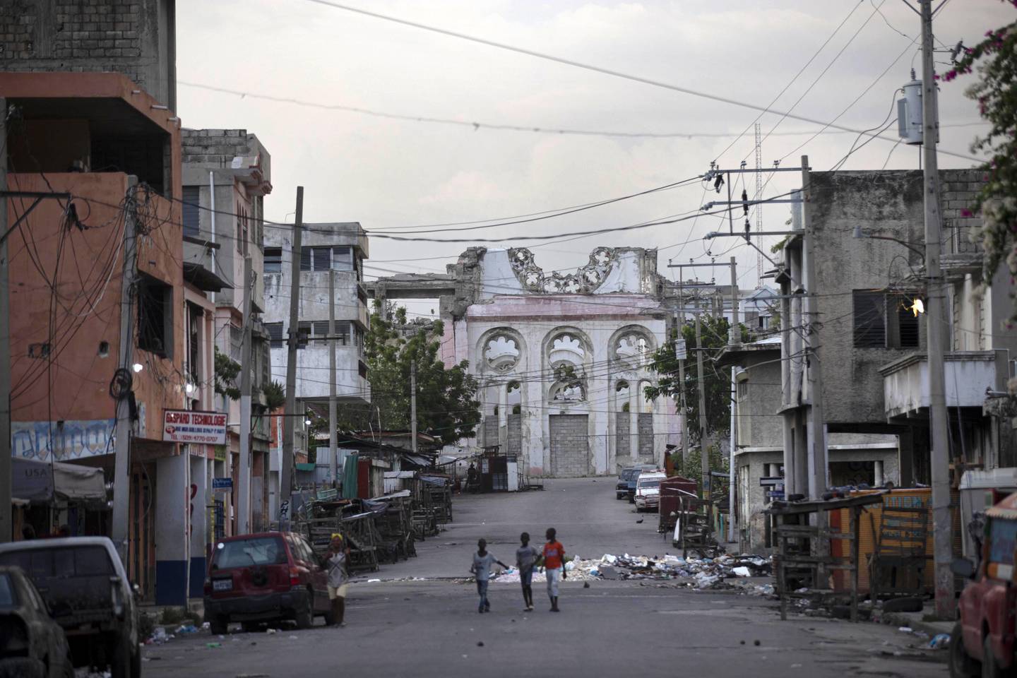Children walk on an empty street in front of the cathedral that was destroyed by the 2010 earthquake in Port-au-Prince, Haiti. AP