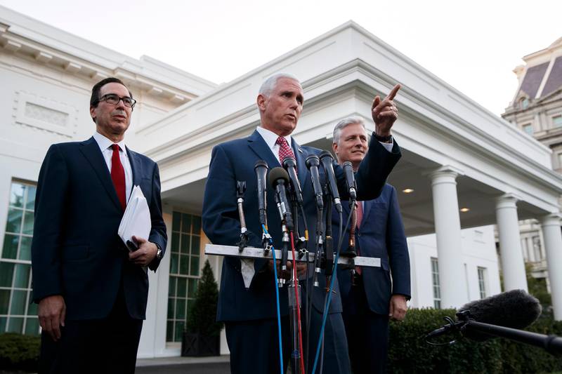Vice President Mike Pence, with Treasury Secretary Steven Mnuchin, left, and national security adviser Robert O'Brien, speaks to reporters outside the West Wing of the White House, in Washington. The U.S. is calling for an immediate ceasefire in Turkey's strikes against Kurds in Syria, and is sending Pence to lead mediation effort AP Photo