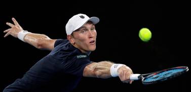 Mitchell Krueger of the US reaches for a backhand return to Serbia's Novak Djokovic during their first round match at the Australian Open. AP