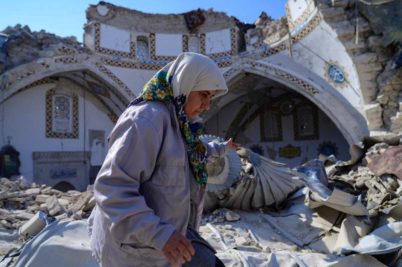 A woman walks by the destroyed Habib-i Neccar mosque in the historic southern city of Antakya in Hatay, Turkey. AFP