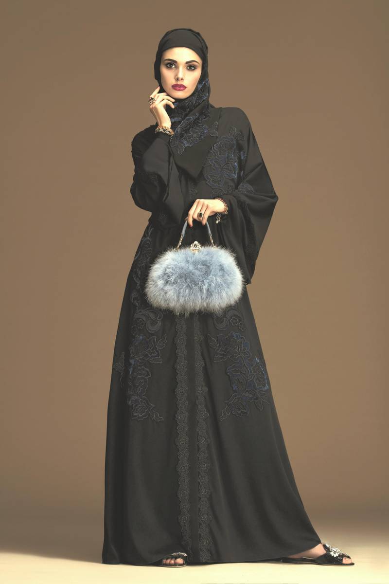 Subtle midnight blue embroidery on a black abaya is a great eveningwear option, especially when combined with a statement bag