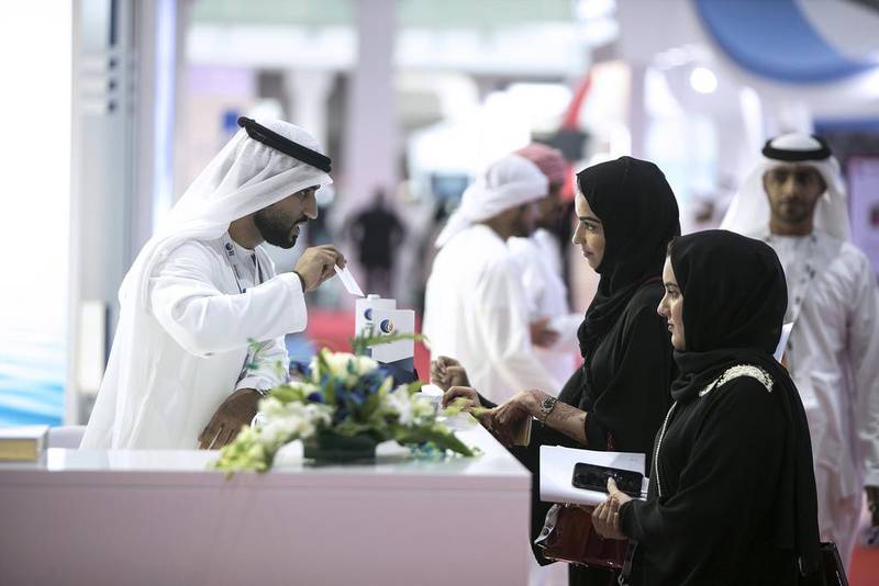 UAE nationals speak to recruiters at at Tawdheef, a job fair open to Emiratis, at Abu Dhabi National Exhibition Centre. Silvia Razgova / The National