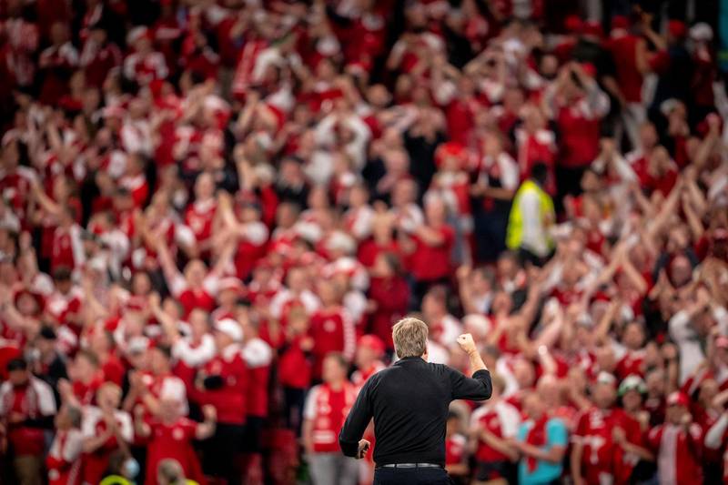 Danish coach Kasper Hjulmand celebrates with Denmark fans after it was confirmed Belgium had beaten Finland 2-0 in the other group match. EPA