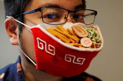 Japanese designer Takahiro Shibata wears a protective mask that looks like a steaming bowl of ramen noodle soup in Yokohama, Japan. Reuters