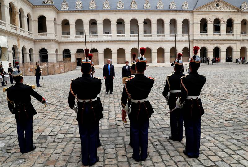 French President Emmanuel Macron and U.S. President Donald Trump review troops during a welcoming ceremony at the Invalides in Paris, France, July 13, 2017. REUTERS/Yves Herman