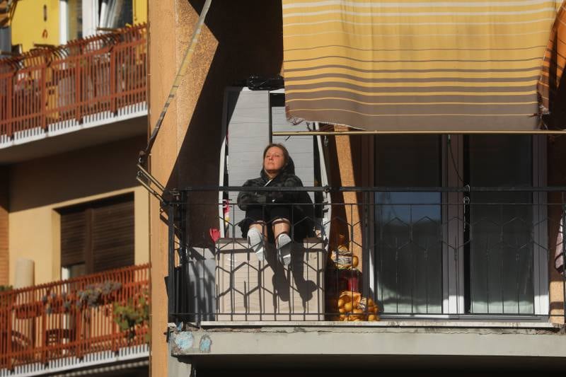 A woman rests on her terrace during lockdown in Rome, Italy. Getty Images