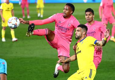 Real Madrid's Eder Militao, left, has tested positive for Covid-19. Reuters