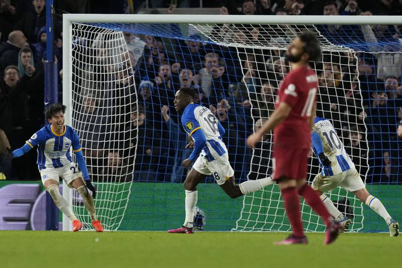 Welbeck celebrates as Liverpool's Mohamed Salah looks dejected. AP