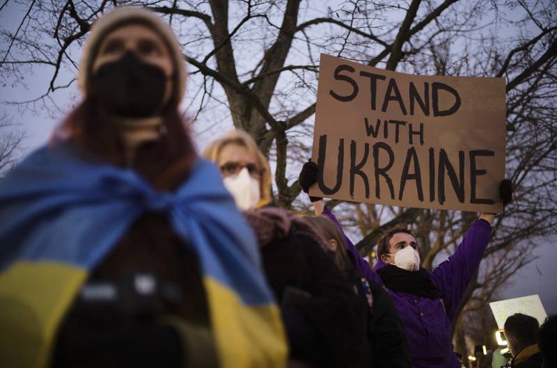 A man shows a poster in support of Ukraine as he protests against the escalation of the tension between Russia and Ukraine, in Berlin. AP