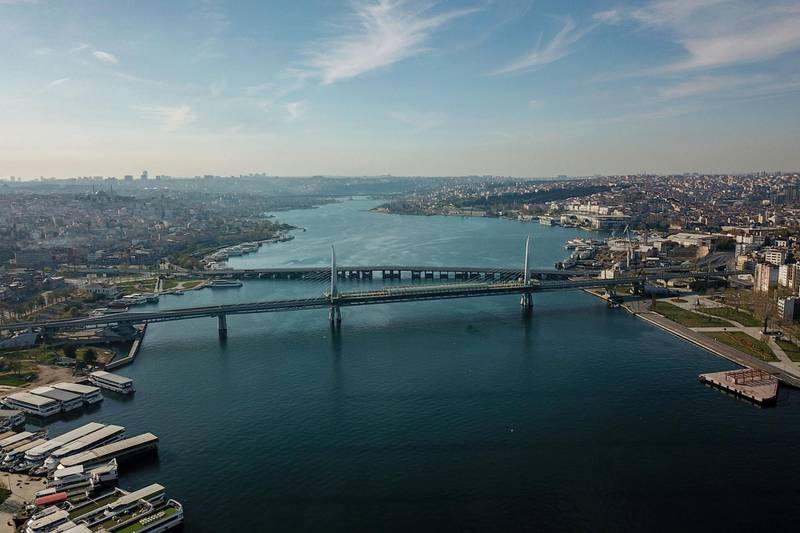The empty shore side of the Golden Horn, with the Metro bridge in the foreground and Unkapani bridge in the background, in Istanbul. AFP