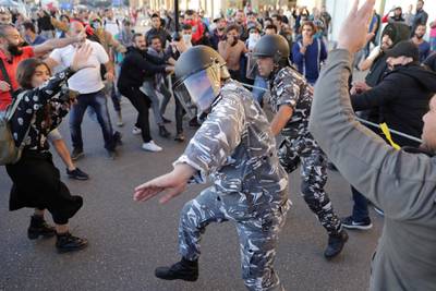Anti-government protesters clash with riot police on a road leading to the parliament building in downtown Beirut. AP Photo