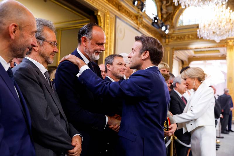 Edouard Philippe, Le Havre mayor and former French prime minister, shakes hands with Mr Macron. Reuters
