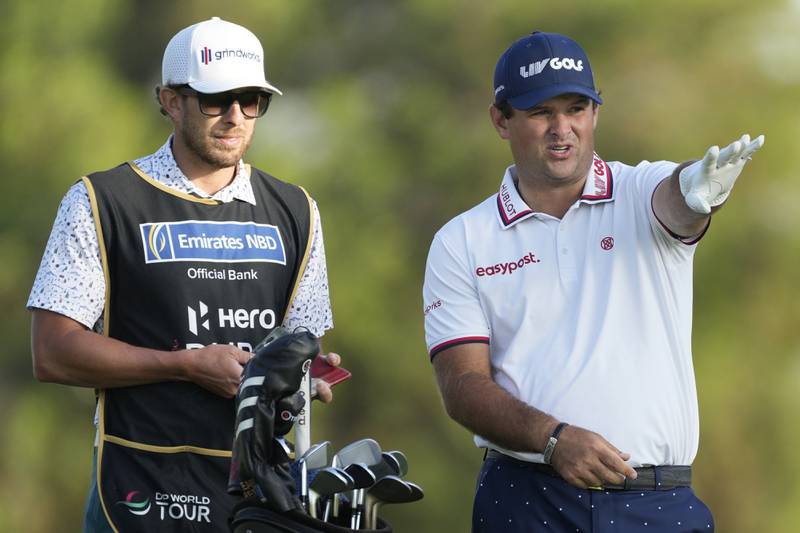 Patrick Reed talks to his caddie on the 18th hole on his way to a third-round 69 that left the American four shots off the lead. AP