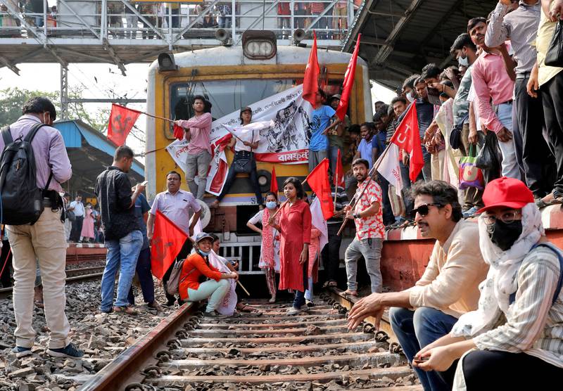 Demonstrators block a passenger train during a two-day strike to protest against what they say are 'anti-people' policies of the central government, in Kolkata, India. Reuters