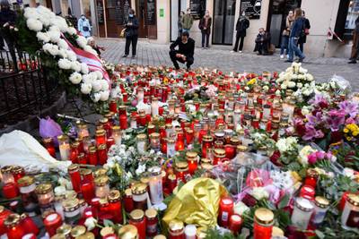 A man lights a candle at the makeshift memorial of candles and flowers at the scene of the attack. Getty Images