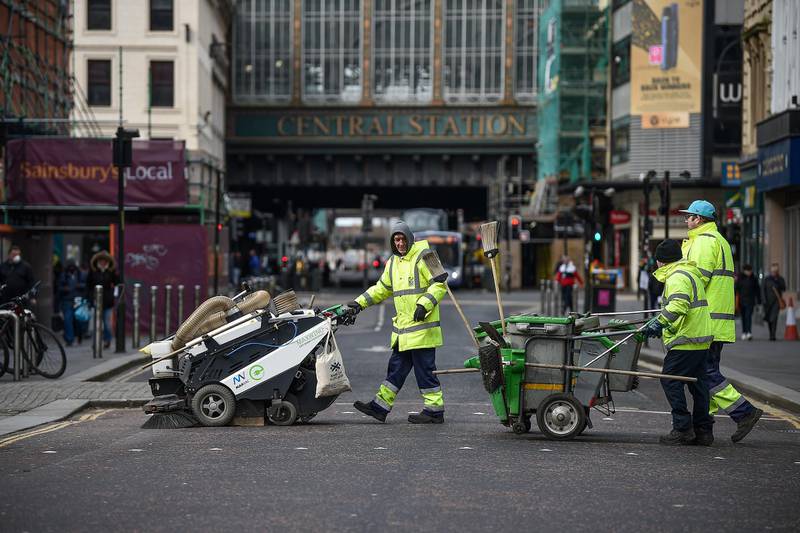 GLASGOW, SCOTLAND - MARCH 21: Street cleaners cross Argyll Street on March 21, 2020 in Glasgow, Scotland. Coronavirus (COVID-19) has spread to at least 182 countries, claiming over 10,000 lives and infecting more than 250,000 people. There have now been 3,269 diagnosed cases in the UK and 144 deaths.  (Photo by Jeff J Mitchell/Getty Images)