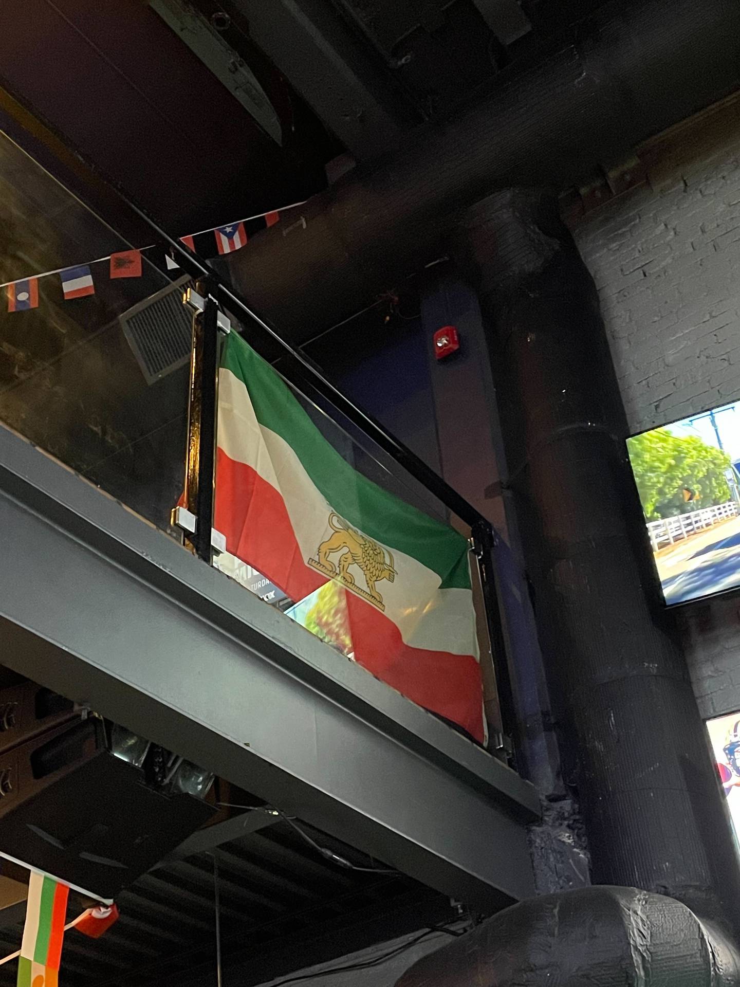 An Iranian flag hangs in Public Bar Live in Washington's trendy Du Pont Circle before the Iran-USA World Cup match. Joshua Longmore / The National