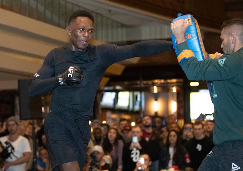UFC middleweight champion Israel Adesanya, left, of Nigeria, works on his timing with coach Andrei Paulet during UFC 248 open workouts, in Las Vegas on Wednesday, March 4, 2020. (Steve Marcus/Las Vegas Sun via AP)