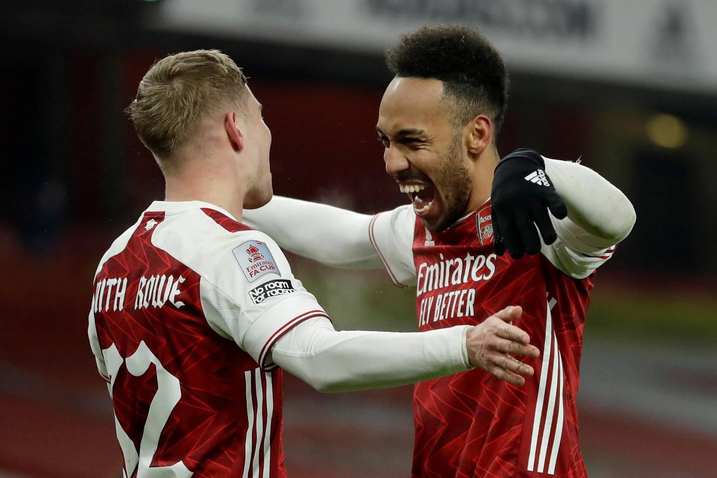 Arsenal's Emile Smith Rowe, left, celebrates with Pierre-Emerick Aubameyang after scoring the opening goal during the English FA Cup third round soccer match between Arsenal and Newcastle United at the Emirates Stadium in London, England, Saturday, Jan. 9, 2020. (AP Photo/Matt Dunham)