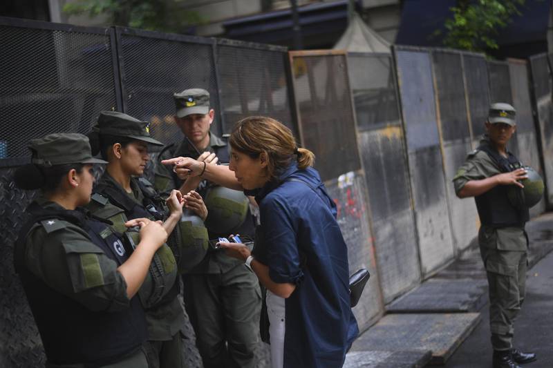 A resident talks to members of National Gendarmerie at a road block. EPA
