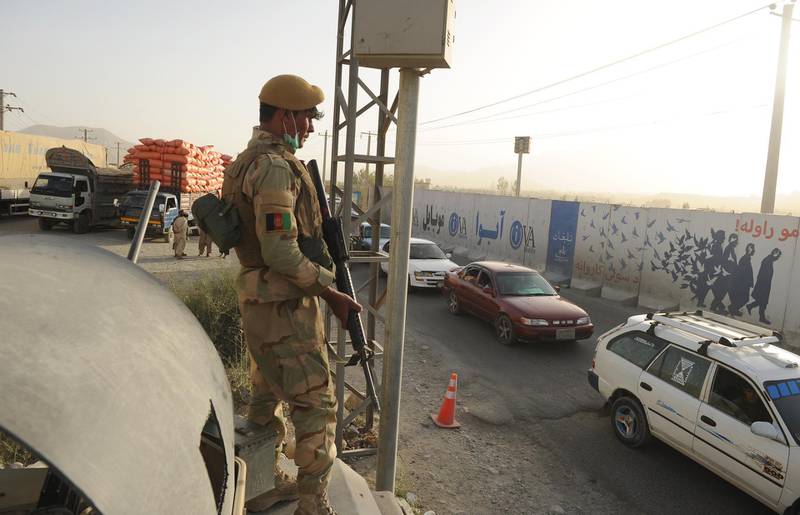 epa06946004 An Afghan national army officer stands guard at the highway of Kabul - Ghazni province, in the outskirt of Kabul, Afghanistan, 12 August 2018. After the attack of Taliban militants on the capital of Ghazni province on 10 August, at least 113 people have been killed and 142 others are injured, according to the sources many parts of the city is under the control of Taliban, as Afghan security forces fight to take back the lost grounds.  EPA/JAWAD JALALI