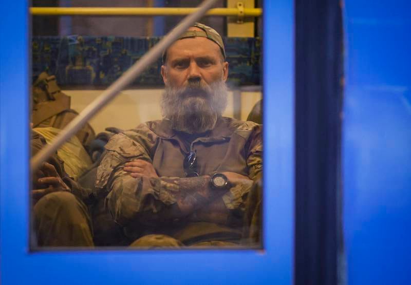 A Ukrainian soldier sits on a bus as troops are evacuated. EPA 
