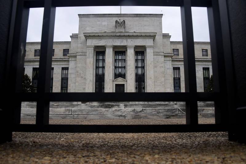 (FILES) In this file photo The Federal Reserve Building is seen through a fence on June 17, 2020 in Washington, DC. The Federal Reserve opened its two-day policy meeting on March 16, 2021 and is expected to provide a more upbeat outlook for the US economy, which will soon be awash in $1.9 trillion in stimulus funds. The extra spending is exactly what Fed Chair Jerome Powell had been urging for months to help repair the damage wrought by the coronavirus pandemic, while also pledging to keep interest rates near zero and continue the bank's massive monthly bond buying program.
 / AFP / Olivier DOULIERY
