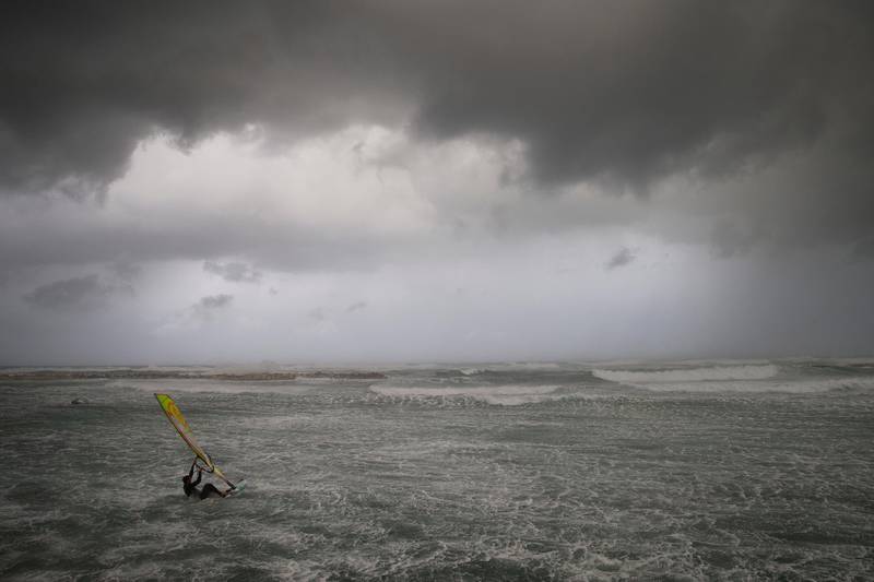 Wind surfers ride on waves in the Mediterranean Sea in Tel Aviv. AP Photo