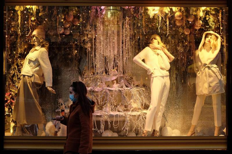 A woman walks past a Christmas festive shop window display as the country's second lockdown came to an end in Galway, Ireland. Reuters