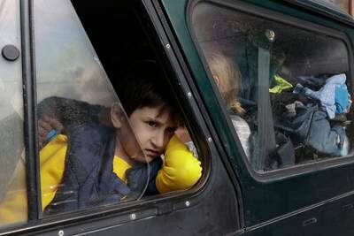 An ethnic Armenian boy from Nagorno-Karabakh, looks on from a car upon arrival in Goris. AP
