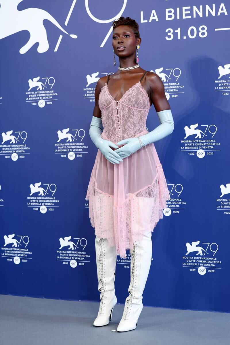 Jodie Turner-Smith wears a sheer Gucci lace negligee-style dress with white thigh-high boots and baby blue gloves for the 'White Noise' photocall. EPA 