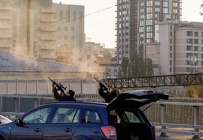 Police officers open fire during a Russian drone strike from Iranian-made Shahed-136 unmanned aerial vehicles. Reuters 