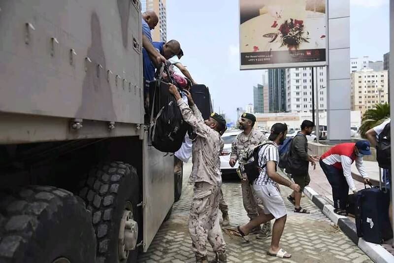 Ministry of Defence personnel help evacuees down from an army truck as they are taken to accommodation. Photo: Ministry of Defence